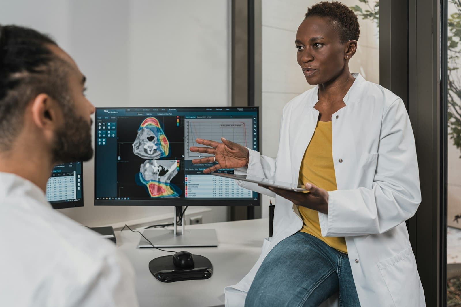 Dr. Baptiste talking through a patient's imaging during a consultation